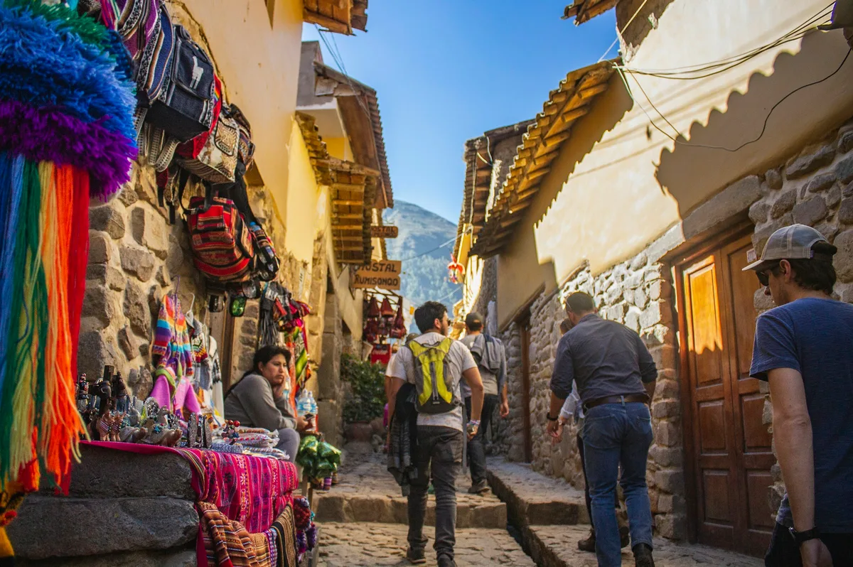 People walking a street in Ollantaytambo, Sacred Valley, Peru
