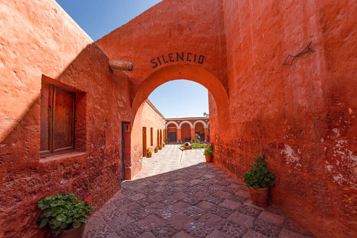 Sunlit stone corridors and painted walls of the Santa Catalina Monastery in Arequipa, Peru